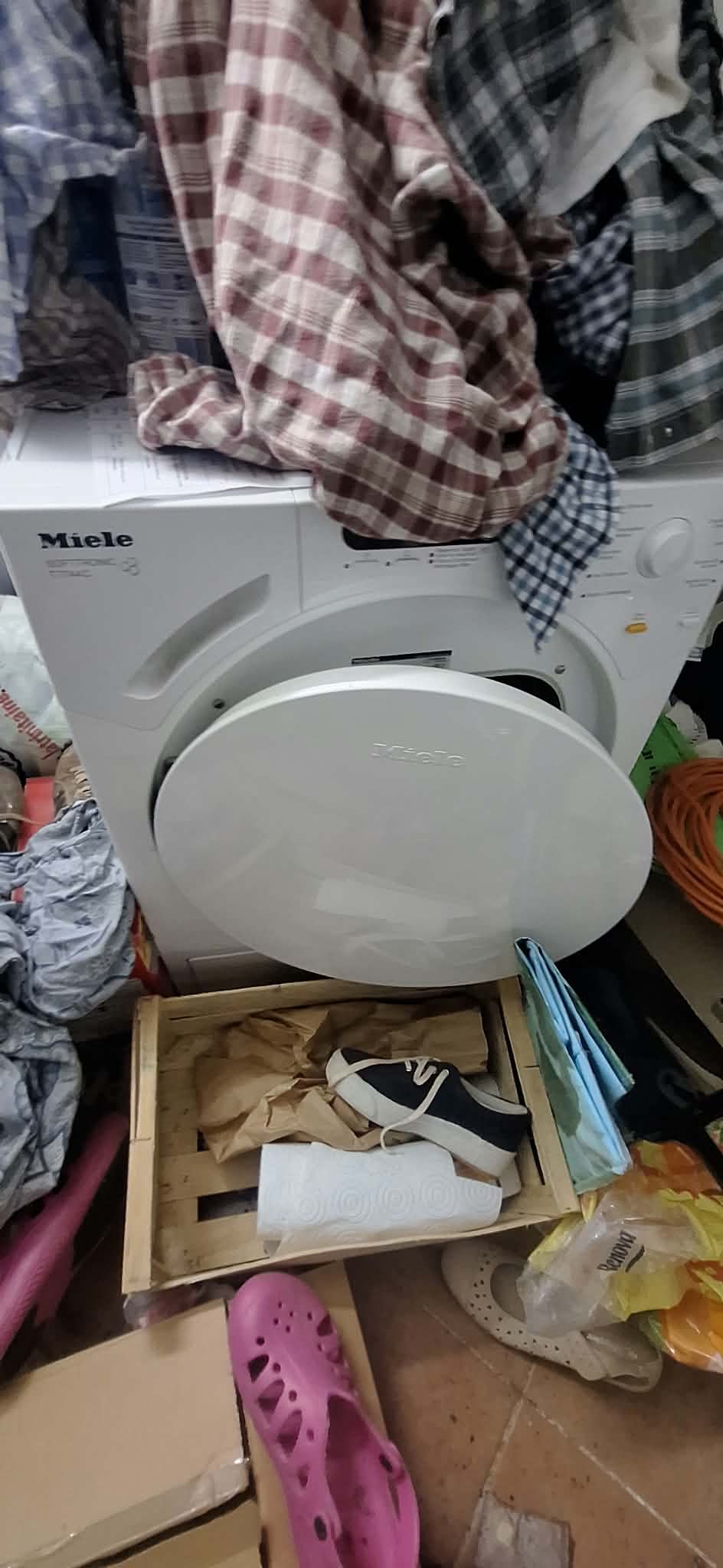 Droogkast en opgehoopte was in een volgestouwde wasplaats vóór de tussenkomst.